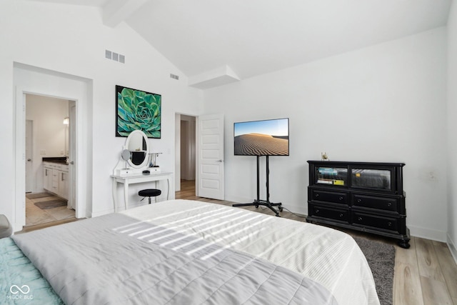 bedroom with light hardwood / wood-style flooring, high vaulted ceiling, beamed ceiling, and ensuite bathroom