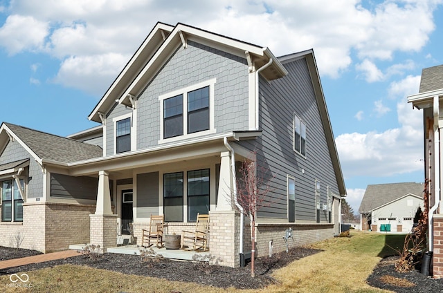 craftsman-style house with covered porch and a front lawn