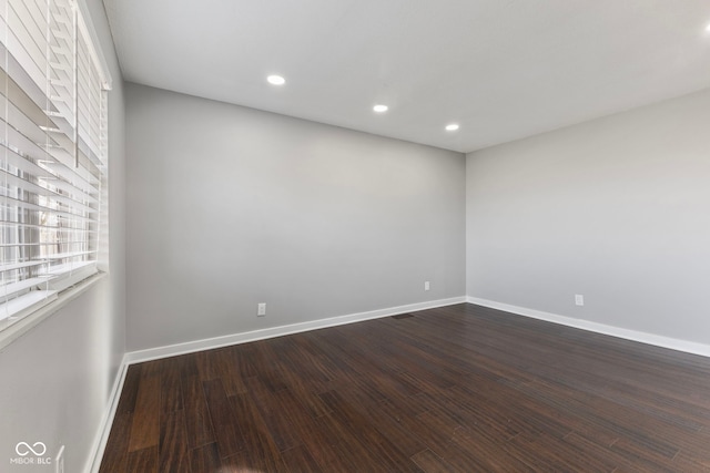 spare room featuring dark hardwood / wood-style flooring