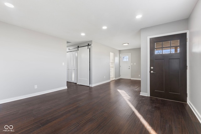 foyer with dark hardwood / wood-style floors and a barn door