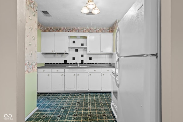 kitchen featuring sink, white appliances, white cabinets, decorative backsplash, and exhaust hood