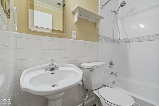 full bathroom featuring tile walls, sink, bathtub / shower combination, and toilet