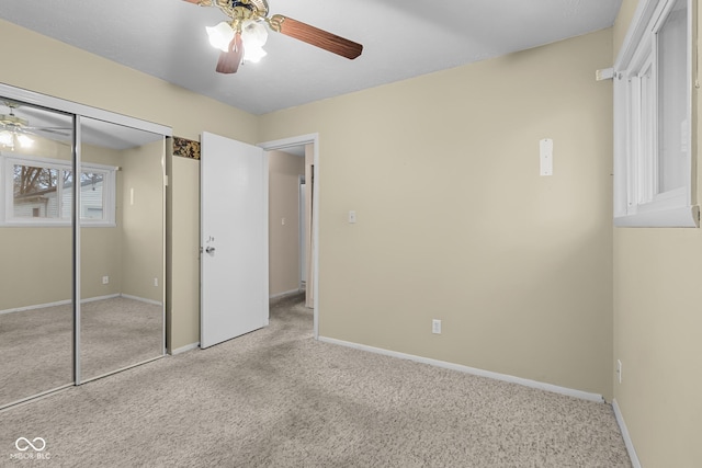 unfurnished bedroom with light colored carpet, a closet, and ceiling fan