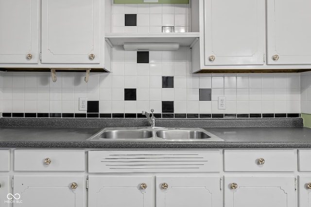 kitchen featuring white cabinetry, sink, and decorative backsplash