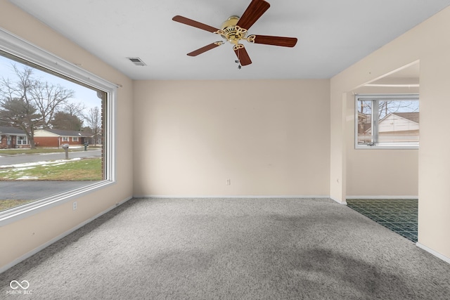 carpeted spare room with ceiling fan