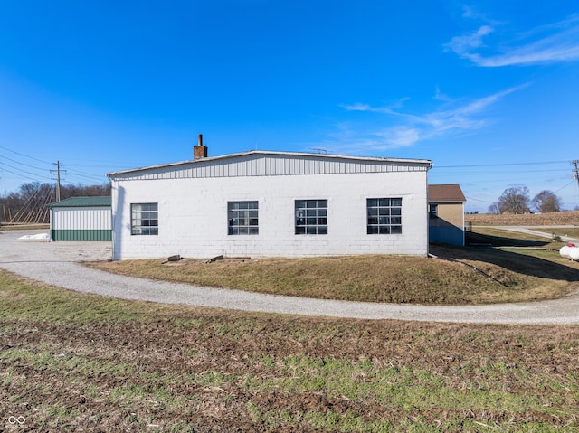 view of side of property with a lawn