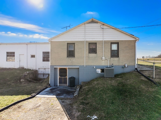 rear view of house featuring a yard and cooling unit