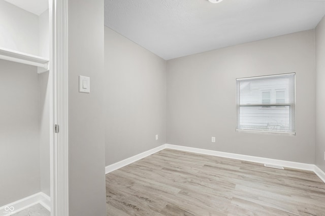 spare room with light hardwood / wood-style flooring