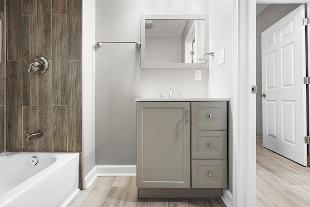 bathroom with vanity, hardwood / wood-style flooring, and shower / bathtub combination