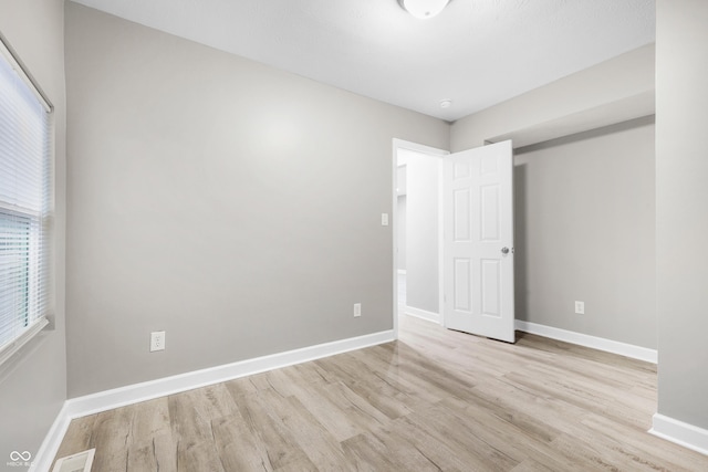 spare room featuring light hardwood / wood-style floors