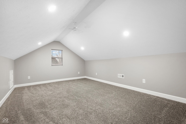 bonus room with vaulted ceiling and carpet