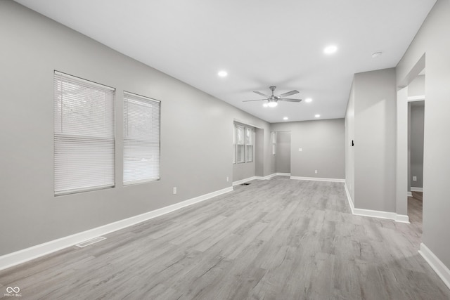 unfurnished room with ceiling fan and light wood-type flooring