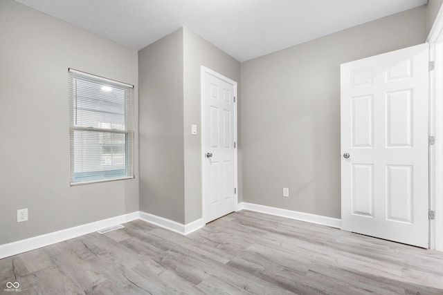 empty room with light wood-type flooring