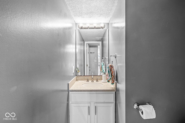 bathroom featuring vanity and a textured ceiling