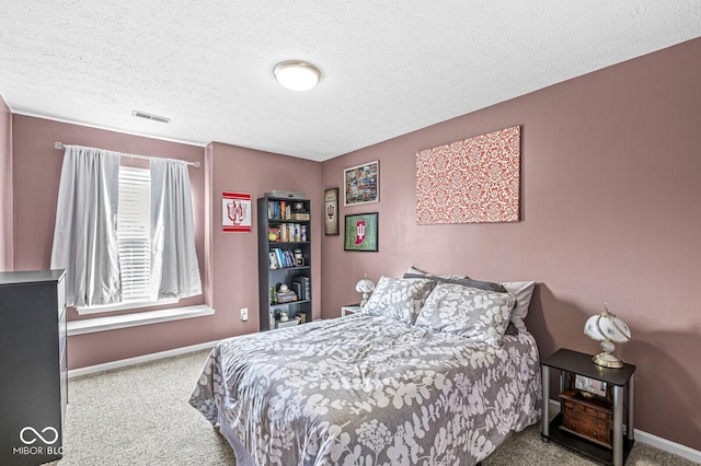 bedroom featuring carpet floors and a textured ceiling