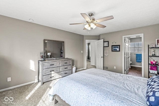 bedroom with connected bathroom, ceiling fan, and carpet