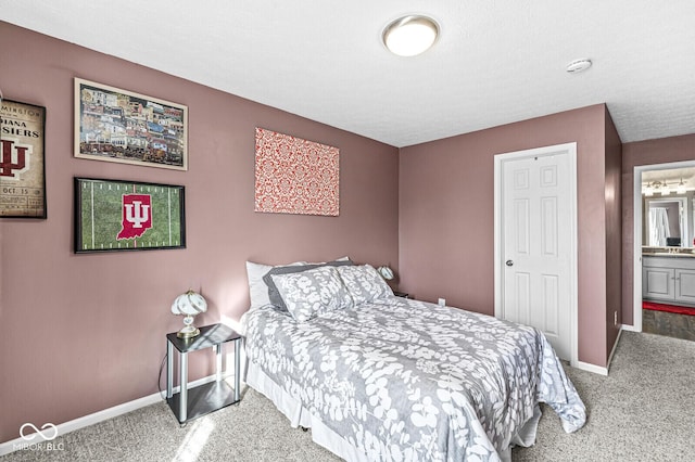 carpeted bedroom featuring ensuite bathroom