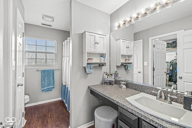 bathroom with vanity, hardwood / wood-style floors, and toilet