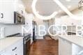 kitchen featuring white cabinetry and dark hardwood / wood-style floors