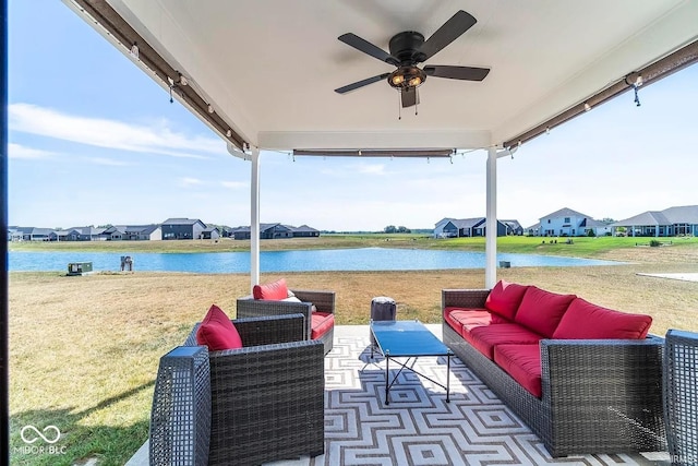 view of patio with a water view, outdoor lounge area, and ceiling fan