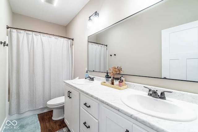 full bathroom with hardwood / wood-style flooring, vanity, toilet, and shower / bath combination with curtain