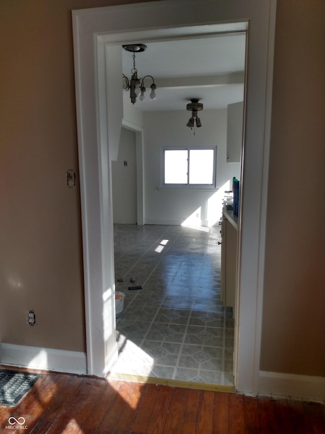 hallway with an inviting chandelier