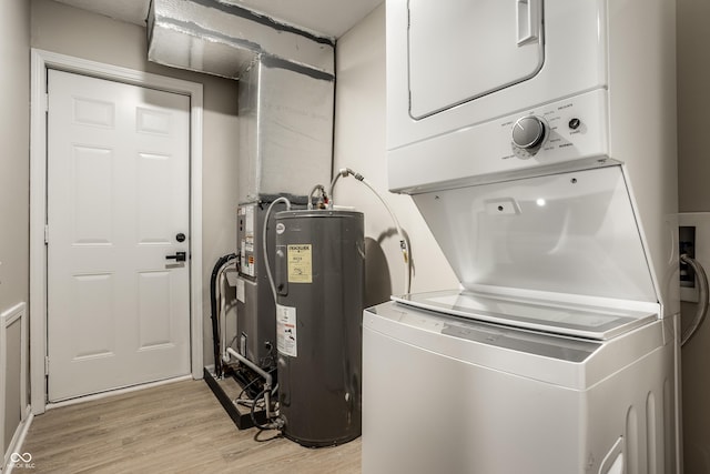 laundry room with stacked washer and dryer, light hardwood / wood-style flooring, and water heater