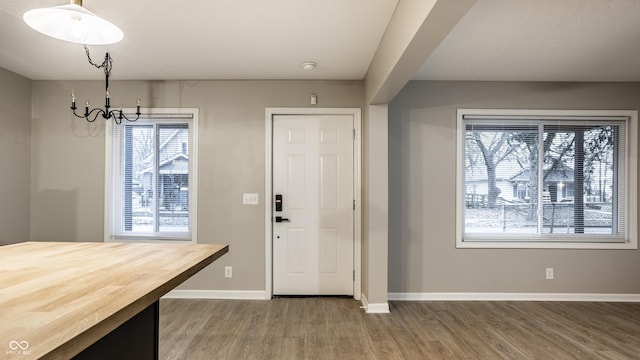 foyer entrance featuring a notable chandelier and hardwood / wood-style floors