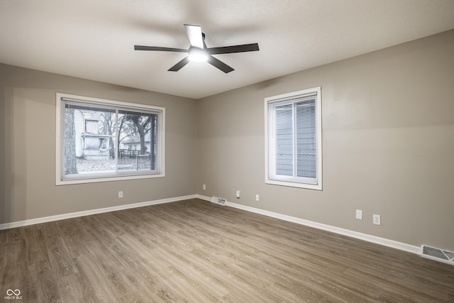 unfurnished room with wood-type flooring and ceiling fan