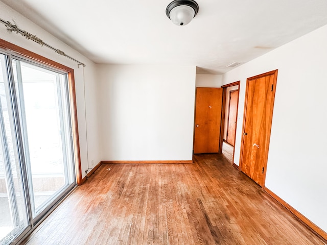 spare room with light wood-type flooring