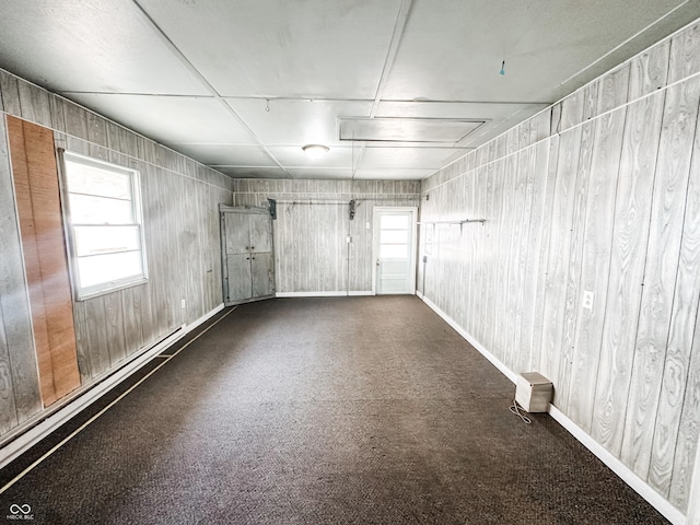 spare room with plenty of natural light and dark colored carpet