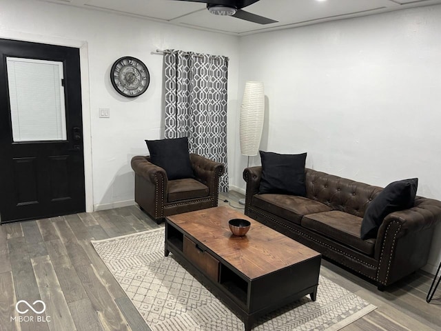 living room with ceiling fan, wood finished floors, and baseboards