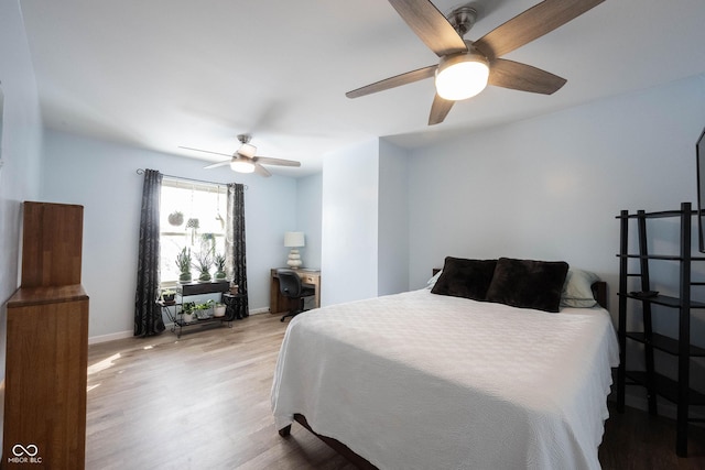 bedroom featuring light wood-type flooring, ceiling fan, and baseboards