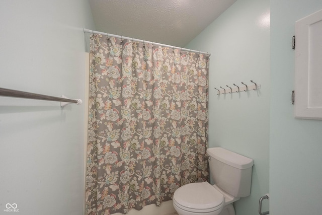 bathroom with toilet and a textured ceiling