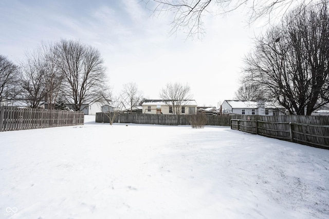 snowy yard with fence