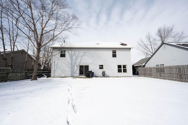 snow covered property featuring fence