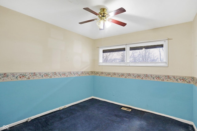 spare room with ceiling fan and carpet