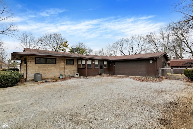 single story home with central AC and a garage