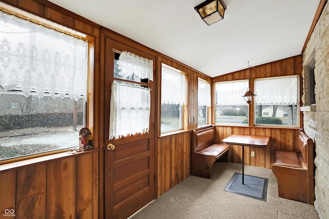 sunroom featuring vaulted ceiling