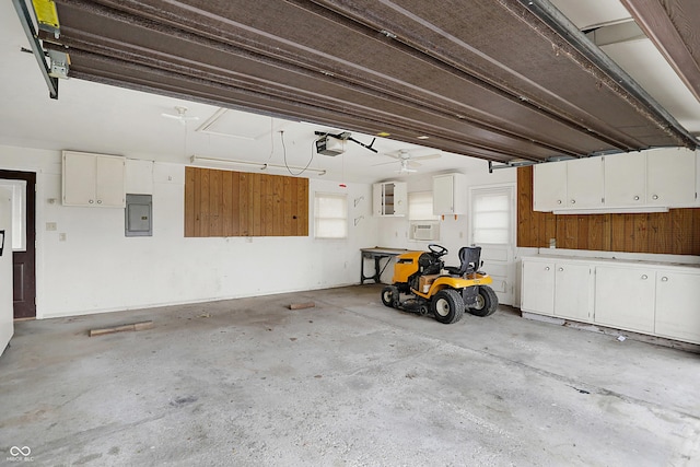 garage with a garage door opener and electric panel