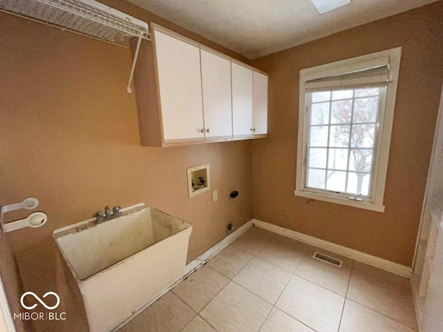 laundry area with sink, cabinets, light tile patterned floors, hookup for a washing machine, and electric dryer hookup