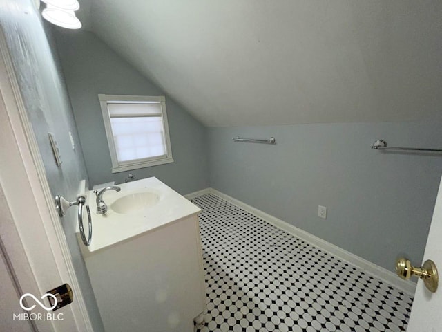 bathroom with vanity and vaulted ceiling