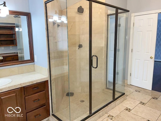 bathroom featuring vanity and an enclosed shower