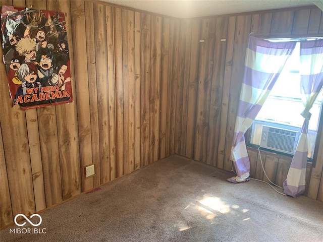 carpeted empty room with cooling unit and wood walls