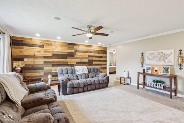 living room with light carpet, crown molding, and wooden walls