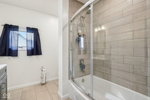 bathroom with enclosed tub / shower combo and vanity