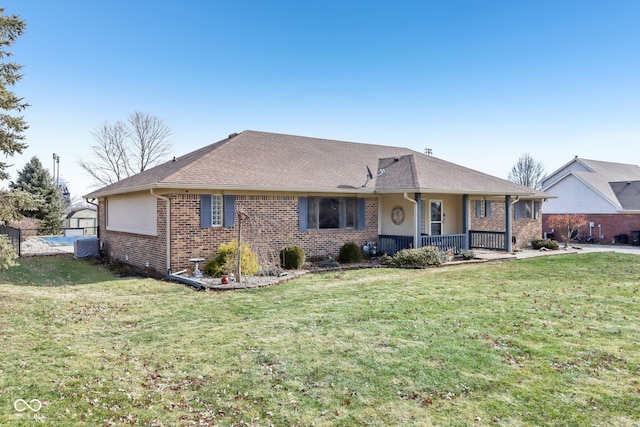 ranch-style house featuring covered porch and a front lawn