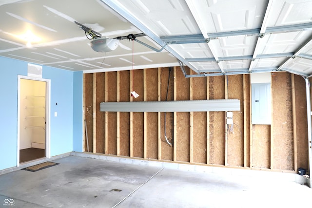 garage with a garage door opener and electric panel