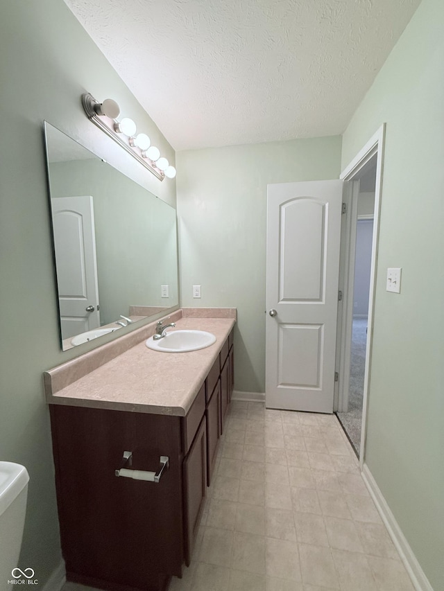 bathroom with vanity and a textured ceiling