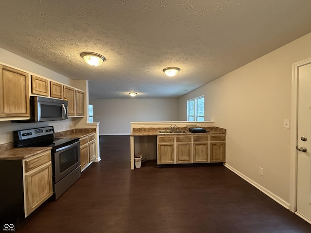 kitchen featuring sink, kitchen peninsula, stainless steel appliances, dark wood-type flooring, and light brown cabinets